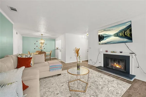 a living room with furniture a flat screen tv and a fireplace