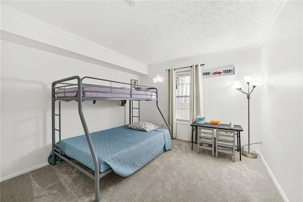 a bedroom with a bunk bed and a desk