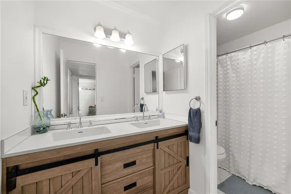 a bathroom with a double vanity sink and a mirror