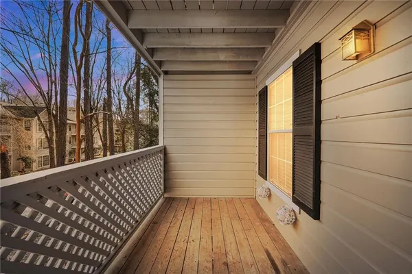 a view of a balcony with wooden floor