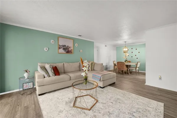 a living room with furniture and wooden floor