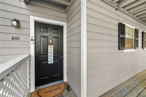 a view of a house with wooden deck