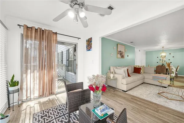 a living room with furniture and wooden floor