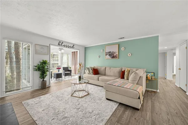 a living room with furniture and wooden floor