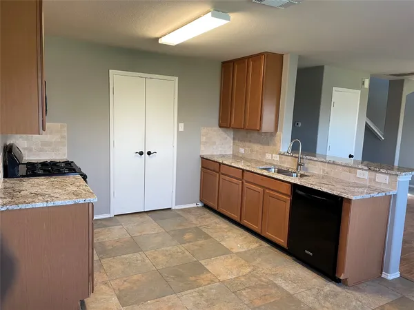 a kitchen with a sink stove and cabinets