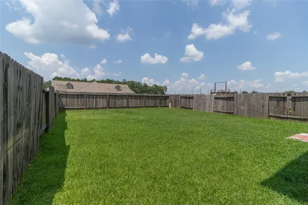 a view of a big yard with a big yard and potted plants