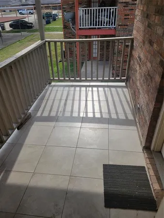 a view of balcony with wooden floor