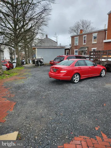 a front view of a house with cars parked