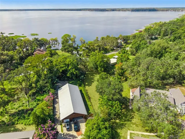an aerial view of a house with a yard basket ball court and outdoor seating