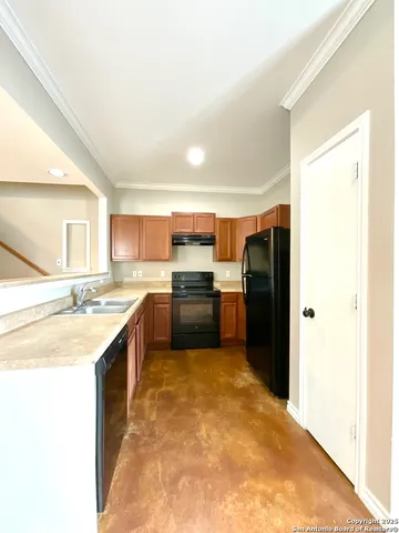 a kitchen with a sink refrigerator and cabinets
