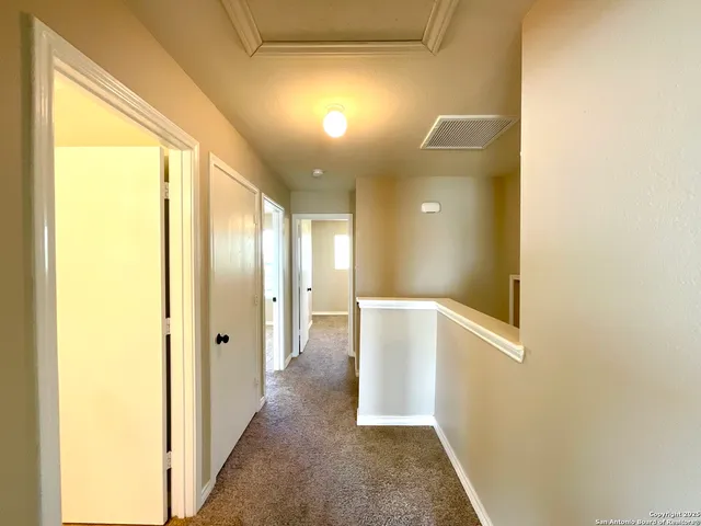 a view of a house with wooden deck and furniture