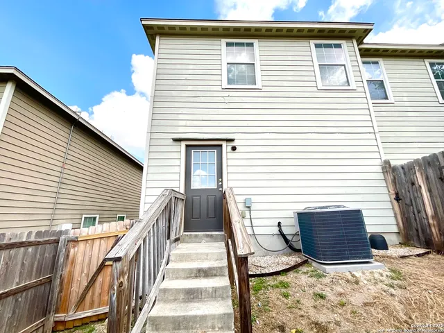 a view of a house with wooden fence