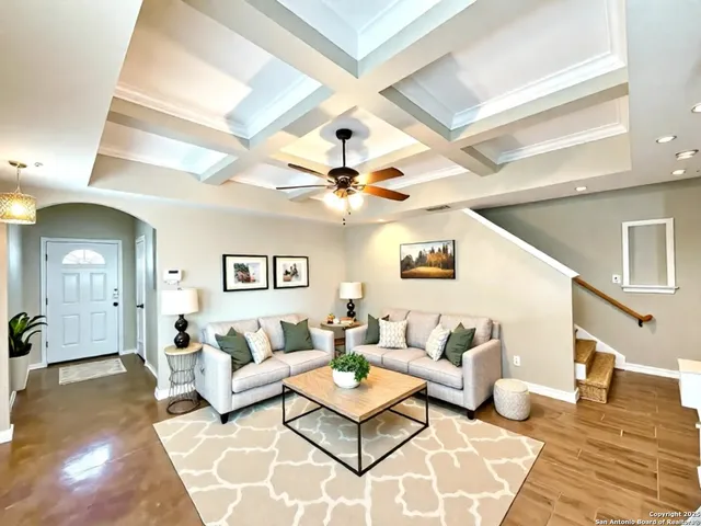 a living room with furniture and a chandelier