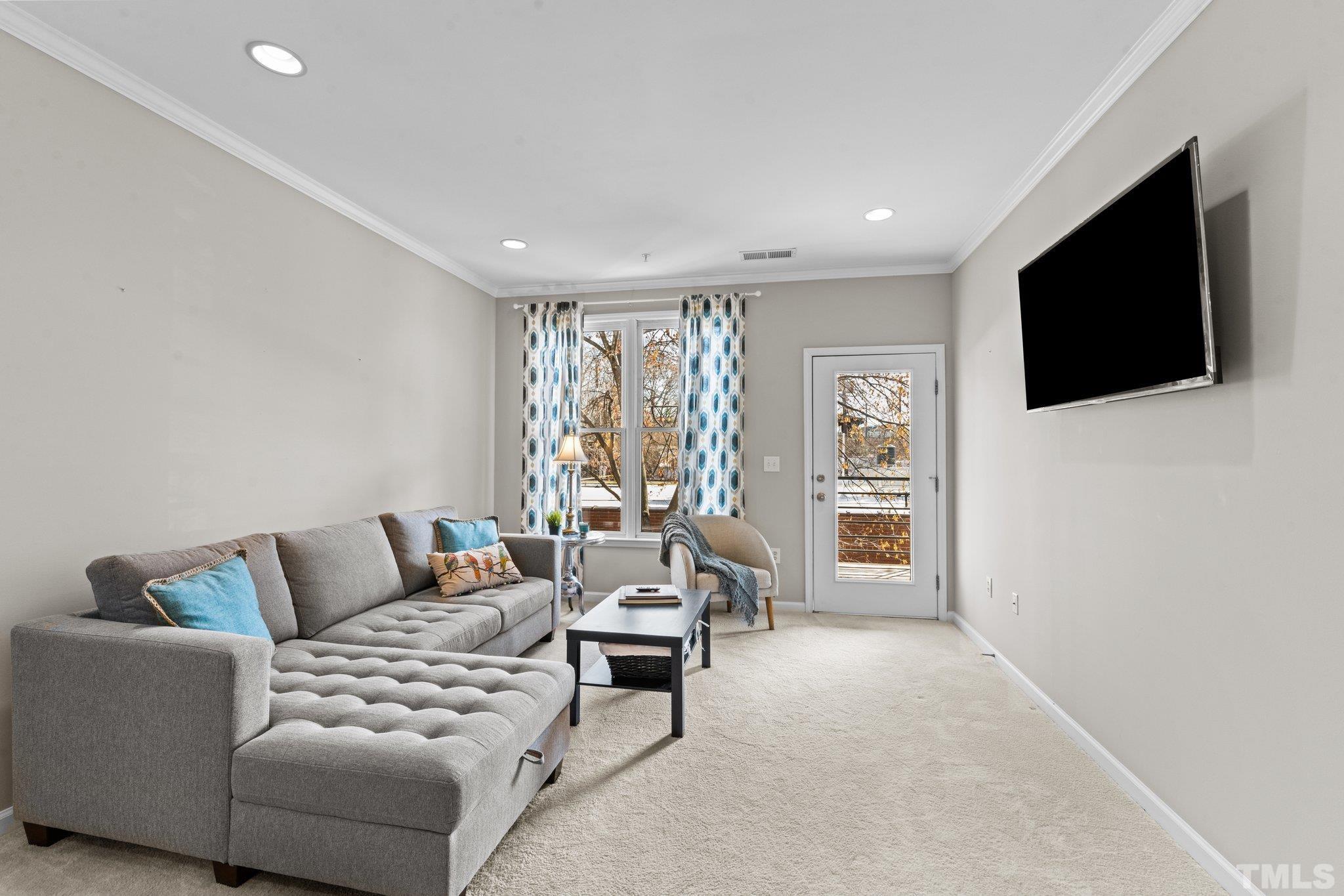 710 North Person Street, Unit 202 Raleigh, NC 27604 - Photo 12 of 33 a living room with furniture and a flat screen tv