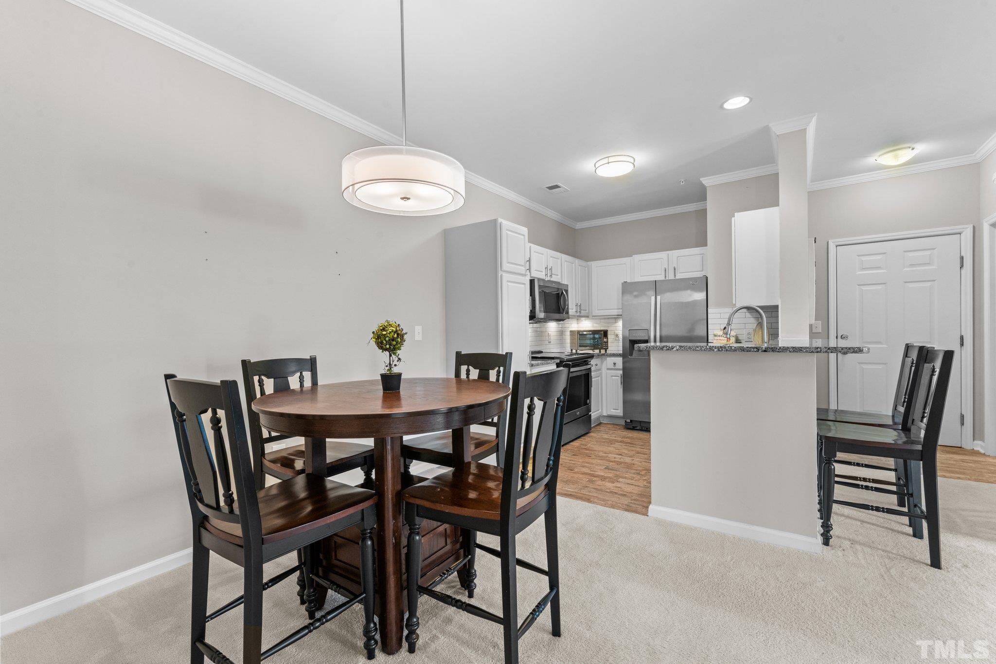 710 North Person Street, Unit 202 Raleigh, NC 27604 - Photo 16 of 33 a view of a dining room that has a table and chairs