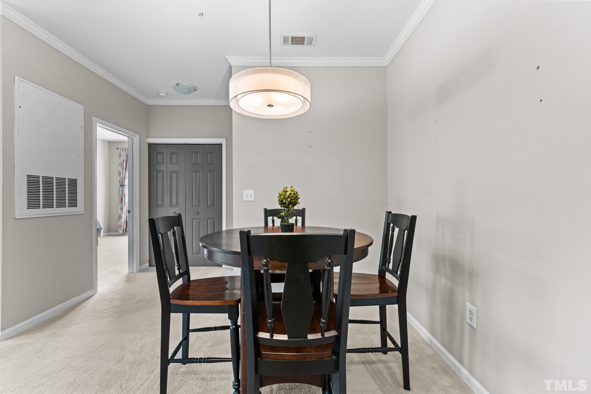 710 North Person Street, Unit 202 Raleigh, NC 27604 - Photo 17 of 33 a view of a dining room with furniture and wooden floor