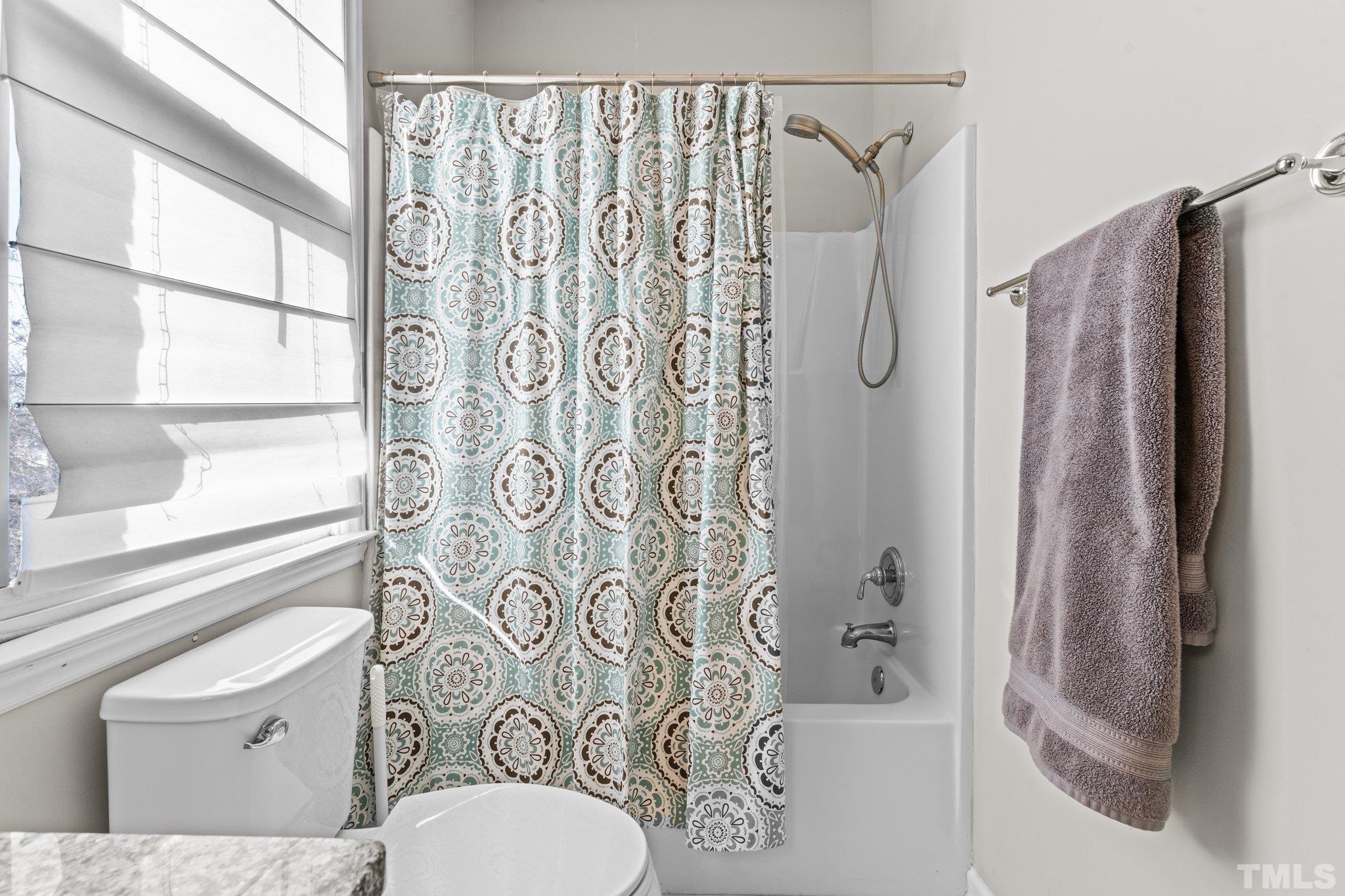 710 North Person Street, Unit 202 Raleigh, NC 27604 - Photo 23 of 33 a bathroom with a shower curtain and a toilet