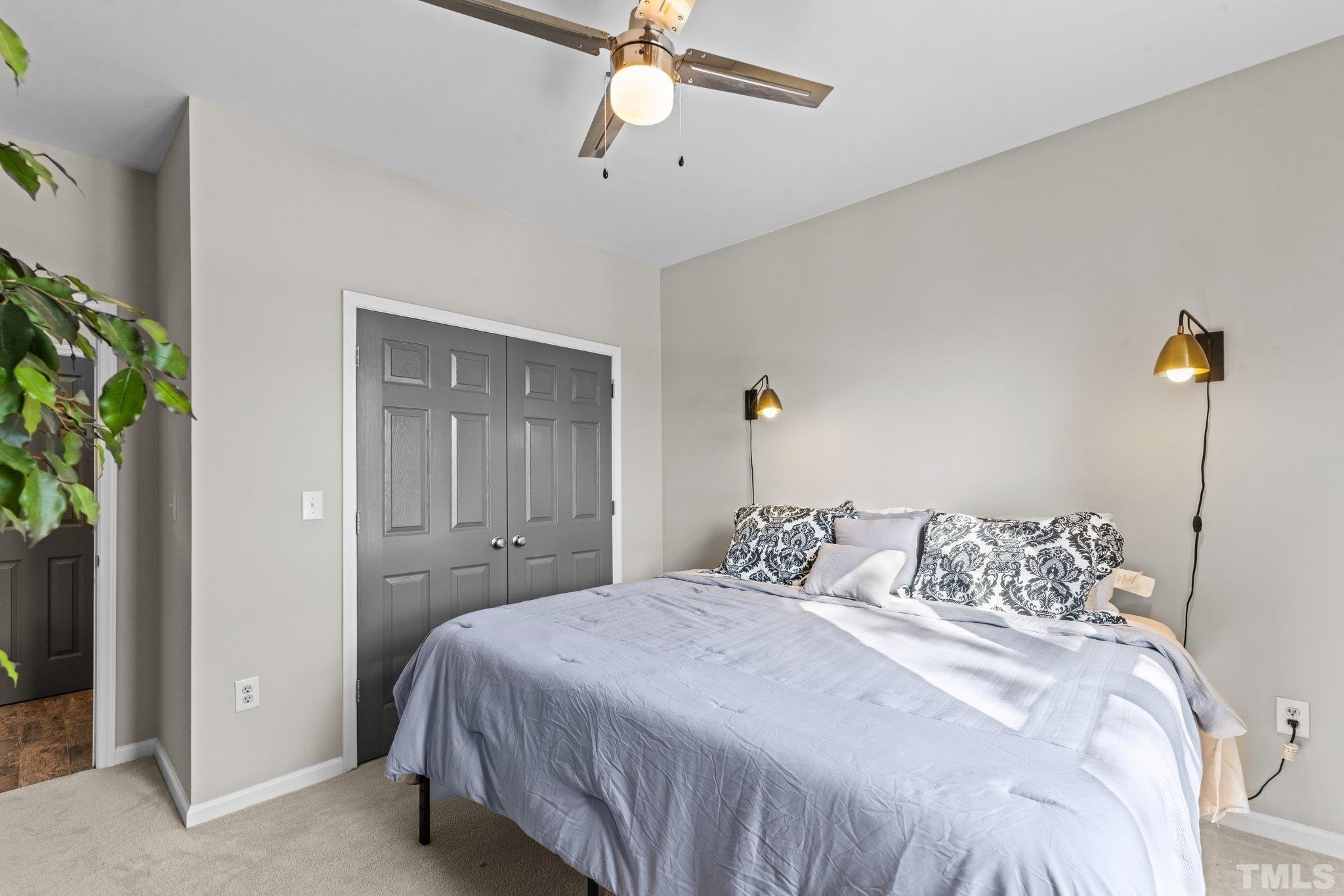710 North Person Street, Unit 202 Raleigh, NC 27604 - Photo 25 of 33 a bedroom with a bed and a potted plant