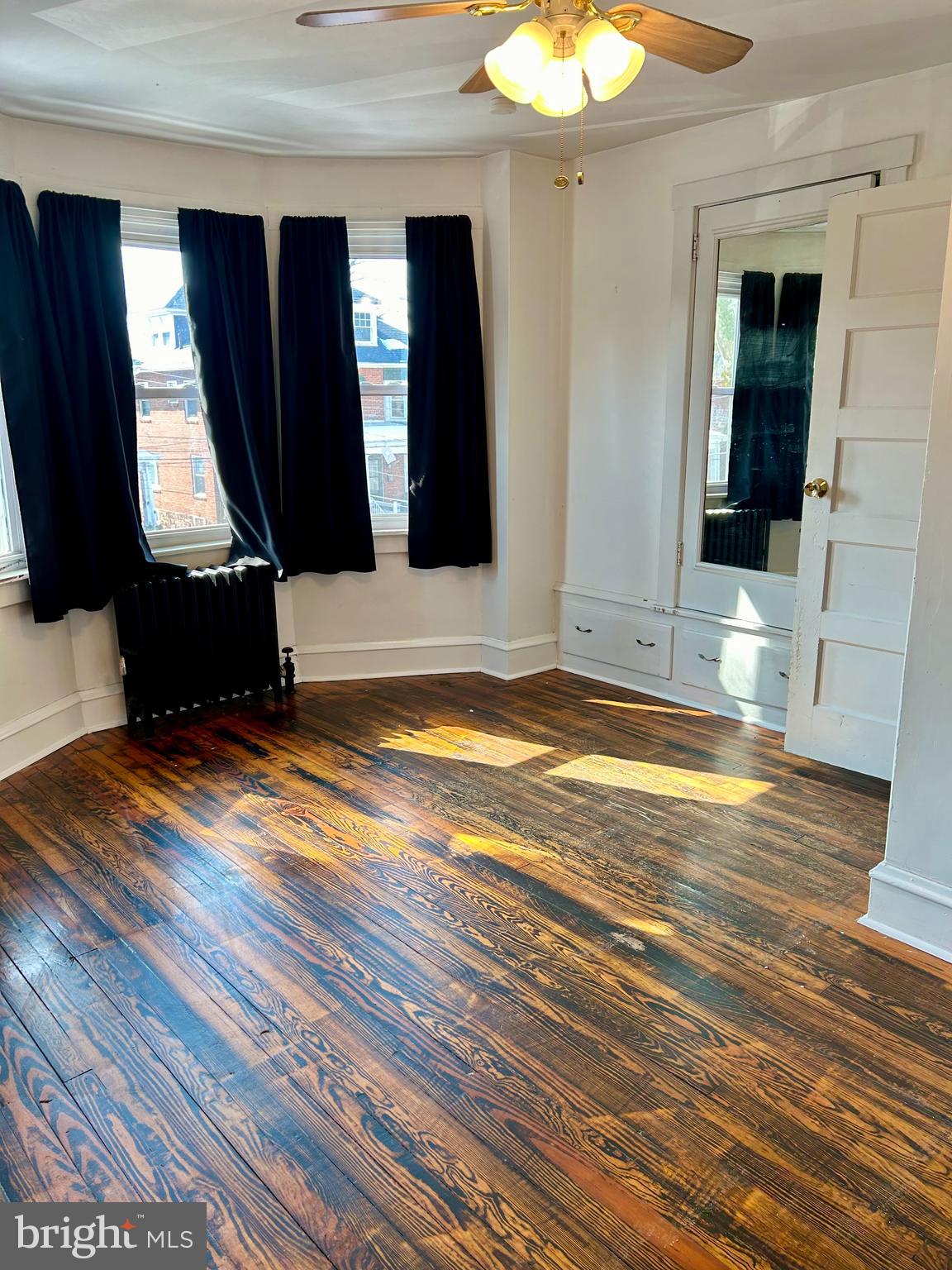 133 East Main Street Pottstown, PA 19465 - Photo 16 of 21 a view of a living room with hardwood floor and a ceiling fan