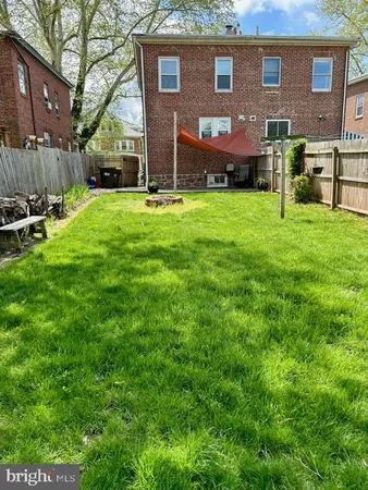a front view of brick house with a yard