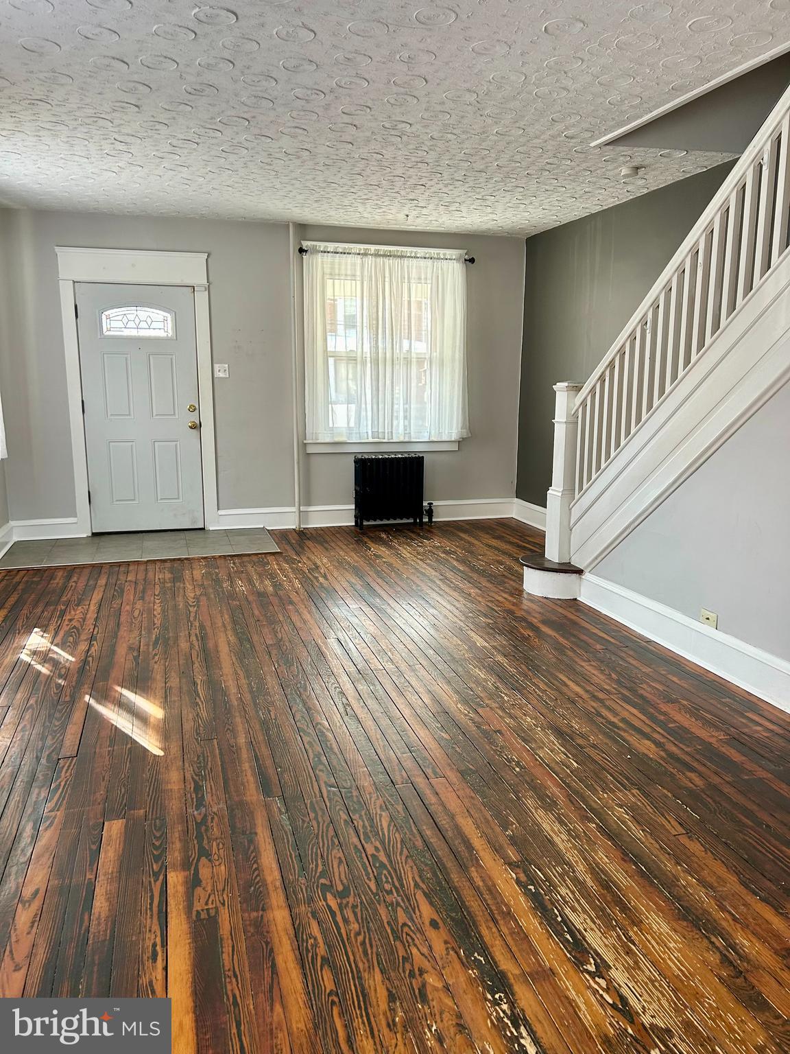 133 East Main Street Pottstown, PA 19465 - Photo 3 of 21 an empty room with wooden floor and windows