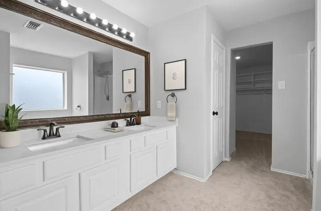 a bathroom with a double vanity sink and a mirror
