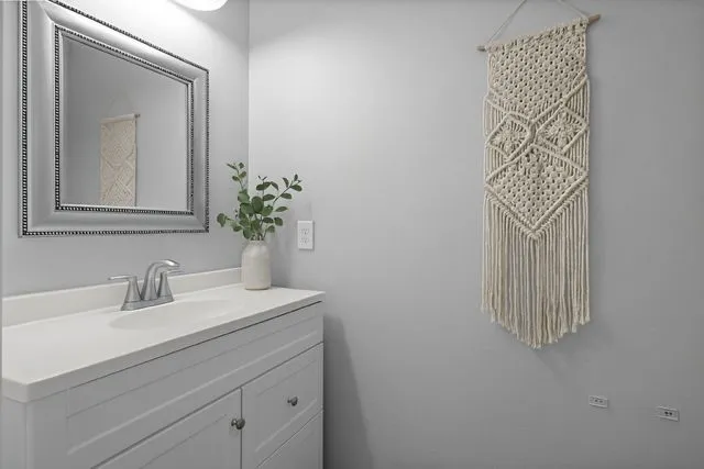a bathroom with a sink a vanity and a mirror