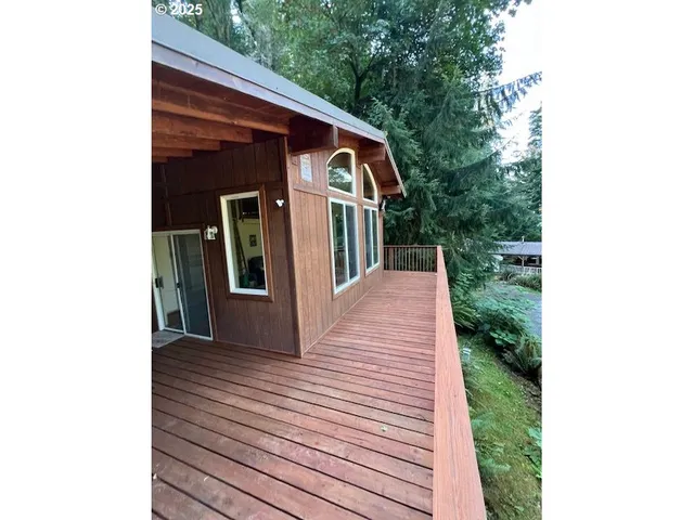 a view of a small house with wooden fence