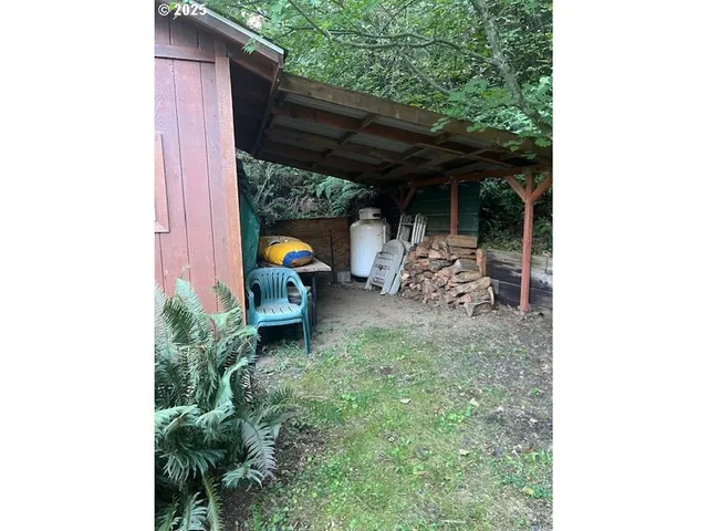 a view of backyard with table and chairs and potted plants