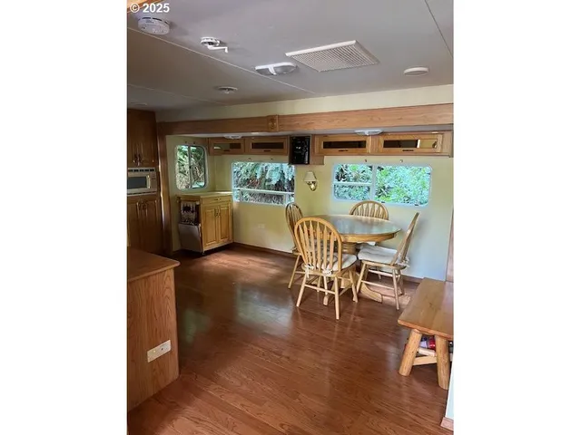 a dining room with furniture and wooden floor