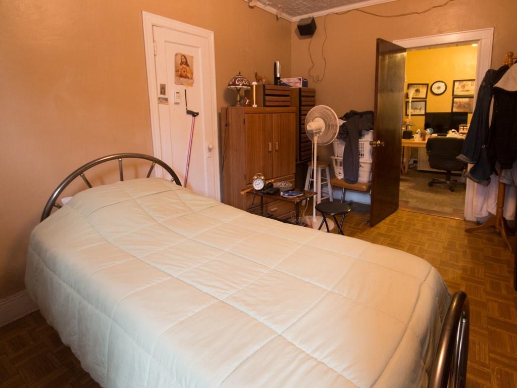 426 Ave Y Brooklyn, NY 11223 - Photo 14 of 25 a bed sitting in a bedroom next to a window