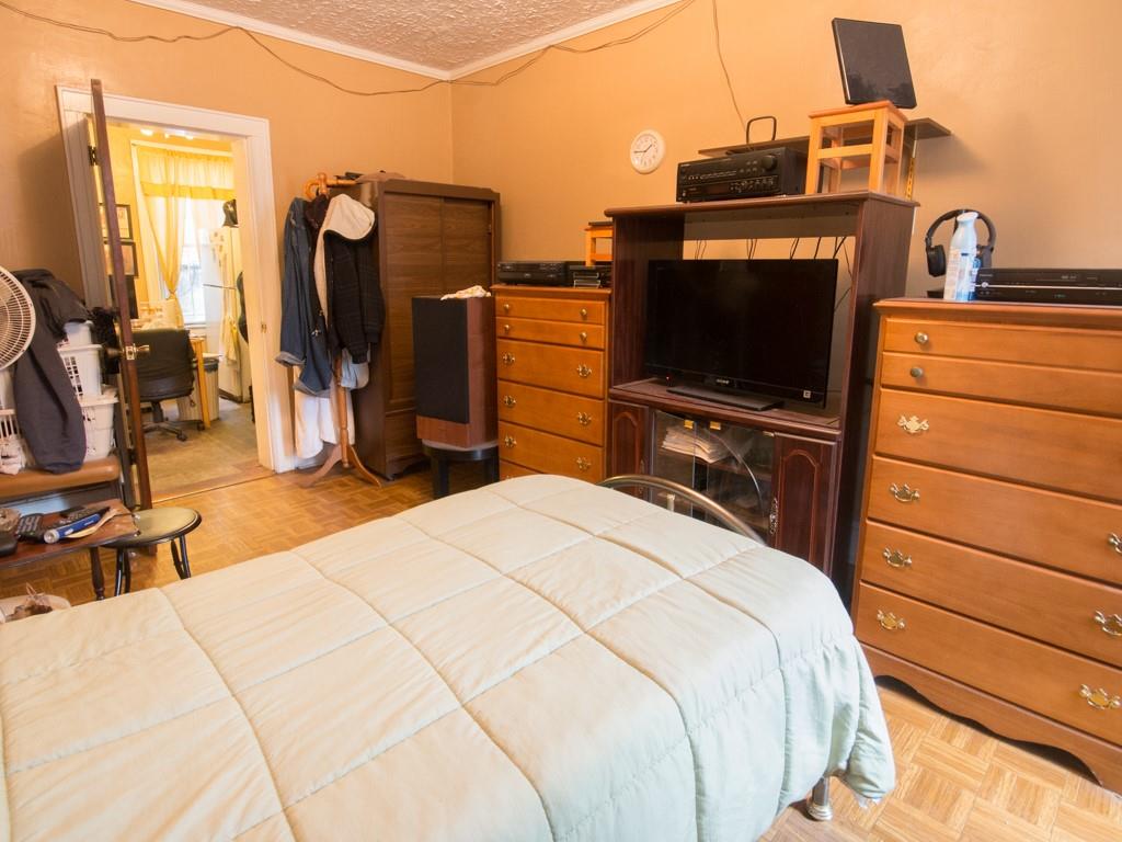 426 Ave Y Brooklyn, NY 11223 - Photo 15 of 25 a bedroom with a bed and a flat screen tv