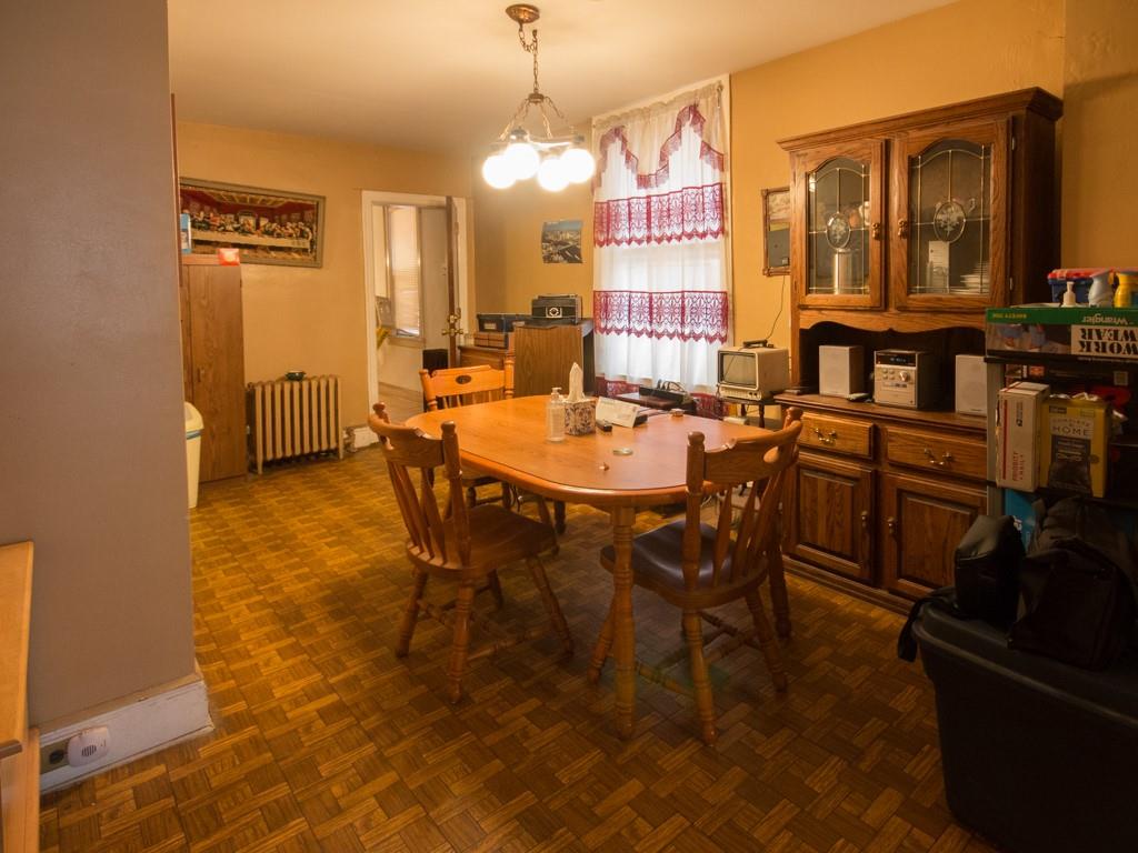 426 Ave Y Brooklyn, NY 11223 - Photo 19 of 25 a dining room with furniture and a chandelier