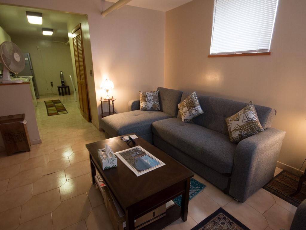 426 Ave Y Brooklyn, NY 11223 - Photo 4 of 25 a living room with furniture and a lamp