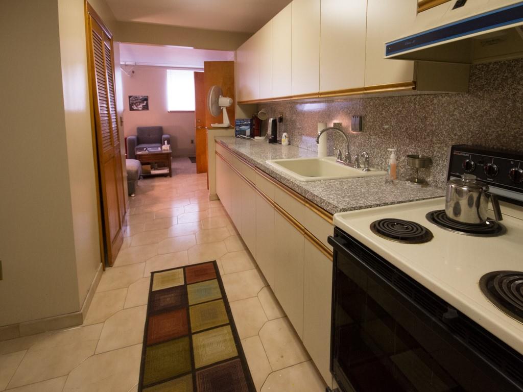 426 Ave Y Brooklyn, NY 11223 - Photo 7 of 25 a kitchen with a sink a stove and cabinets