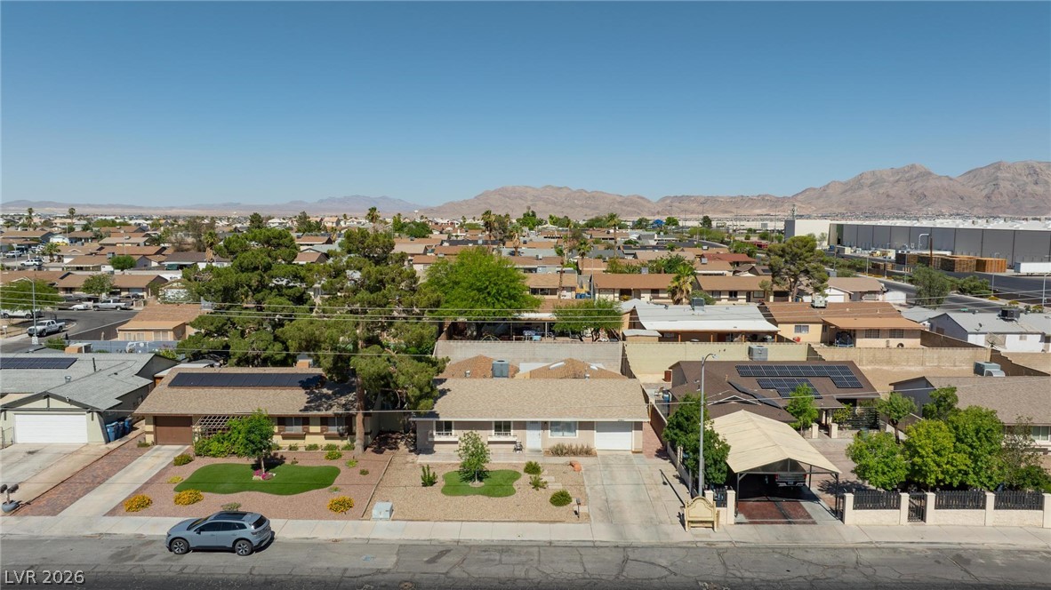 3640 North Walnut Road Las Vegas, NV 89115 - Photo 38 of 38 An aerial perspective reveals a residential neighborhood nestled against a mountainous desert backdrop.