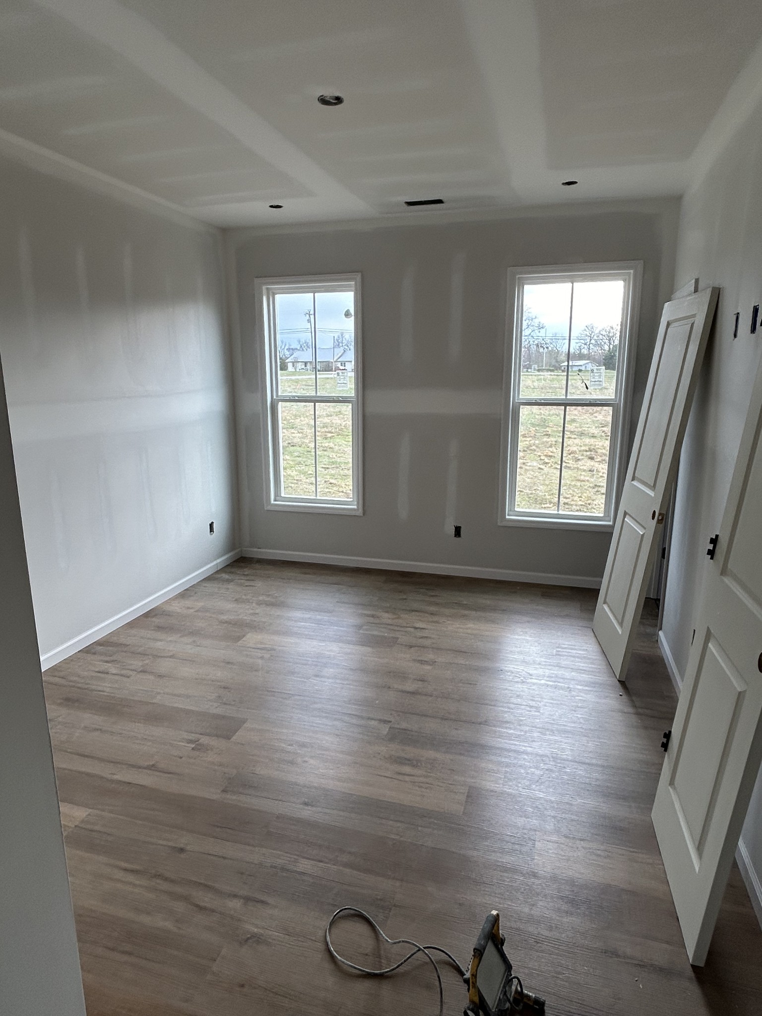 73 Henegar Road Morrison, TN 37357 - Photo 3 of 4 an empty room with wooden floor and windows
