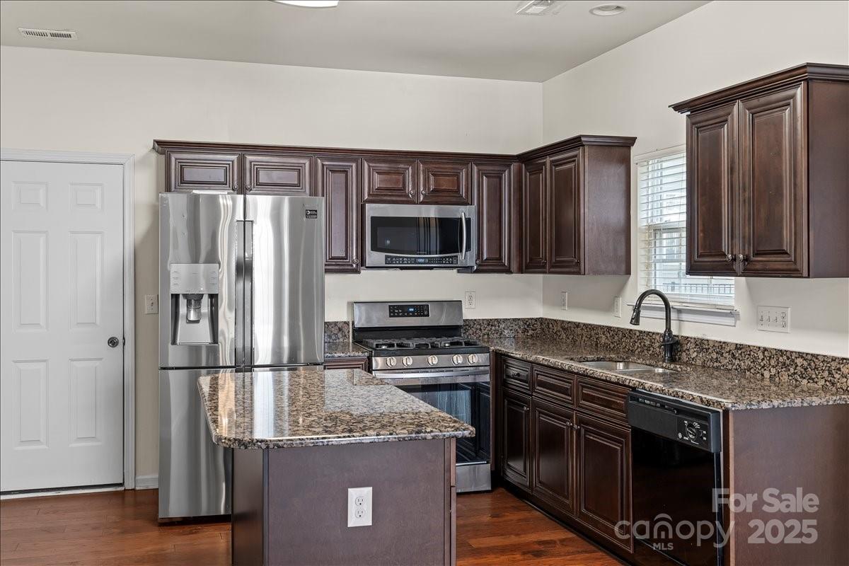 11938 Harmon Lane Pineville, NC 28134 - Photo 14 of 36 a kitchen with granite countertop a sink stove and refrigerator