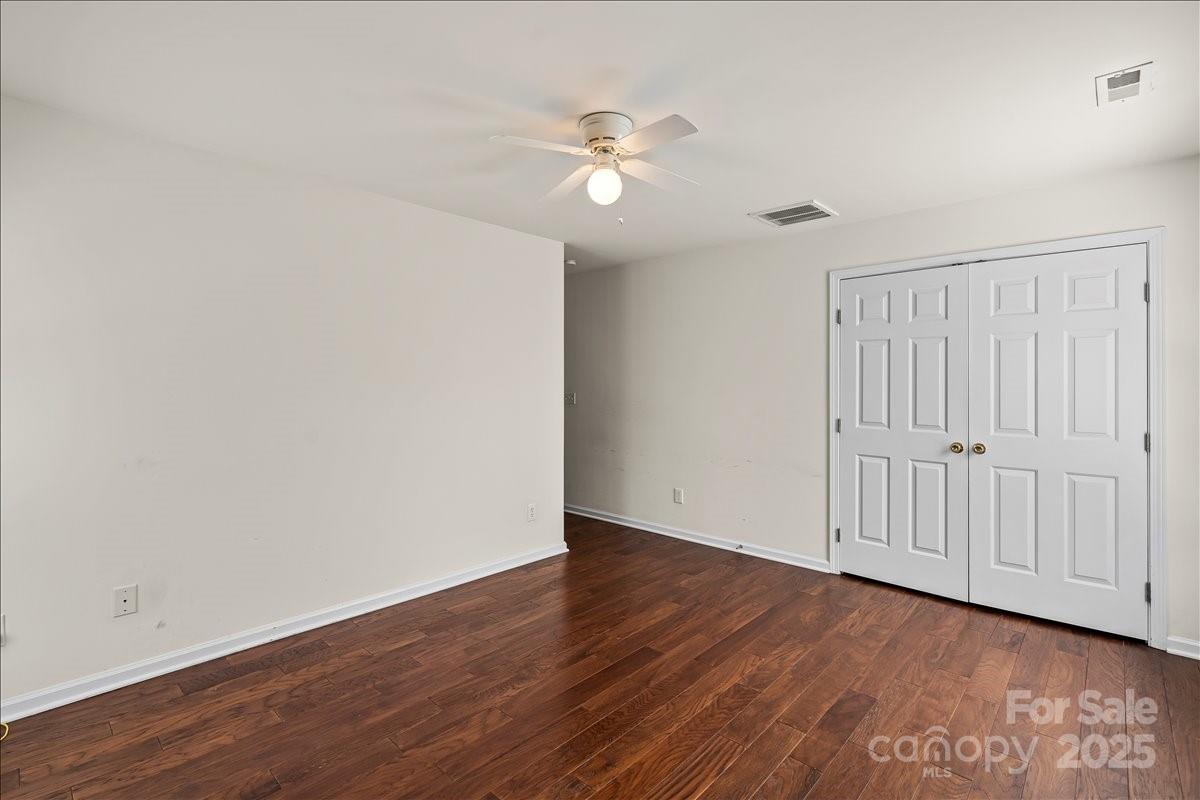 11938 Harmon Lane Pineville, NC 28134 - Photo 22 of 36 a view of an empty room with wooden floor