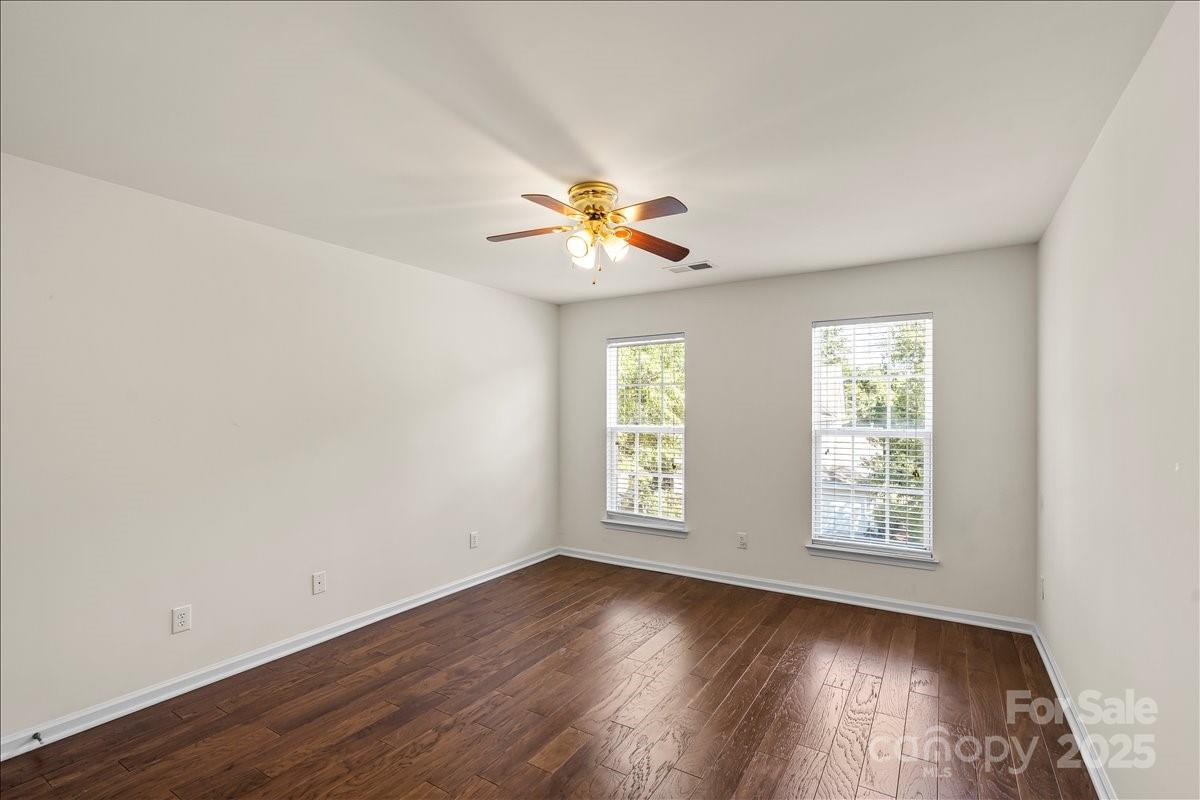 11938 Harmon Lane Pineville, NC 28134 - Photo 25 of 36 an empty room with wooden floor and windows