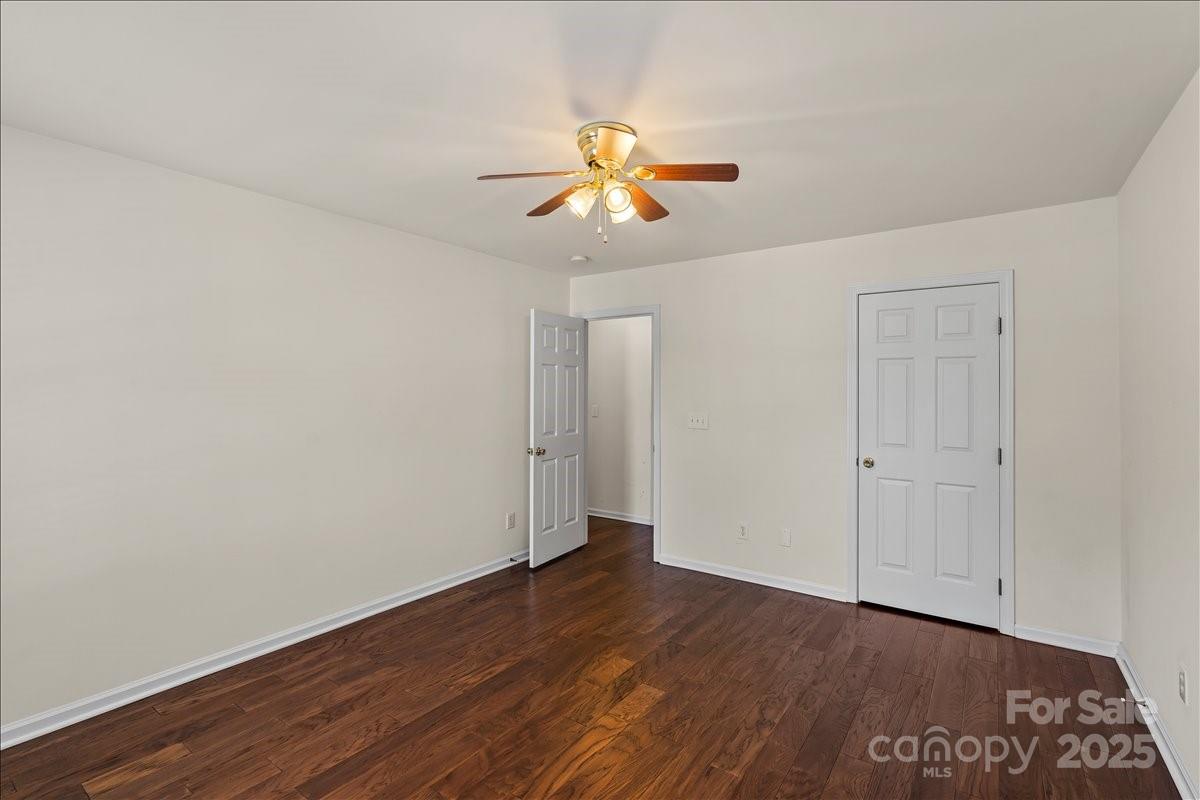 11938 Harmon Lane Pineville, NC 28134 - Photo 26 of 36 a view of an empty room with window and wooden floor