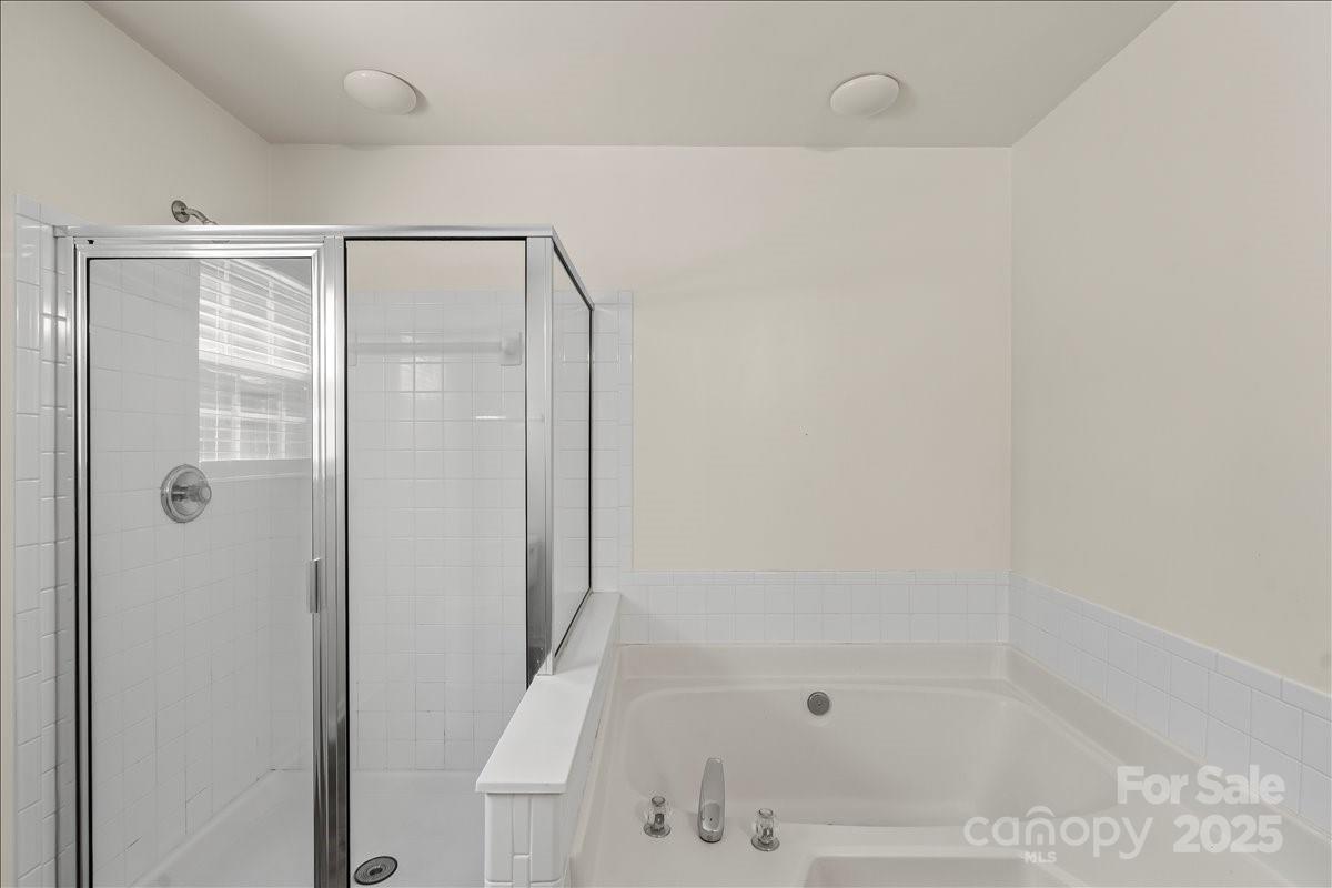 11938 Harmon Lane Pineville, NC 28134 - Photo 27 of 36 a bathroom with a bathtub and a shower