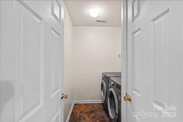 a view of storage and utility room with a washer dryer