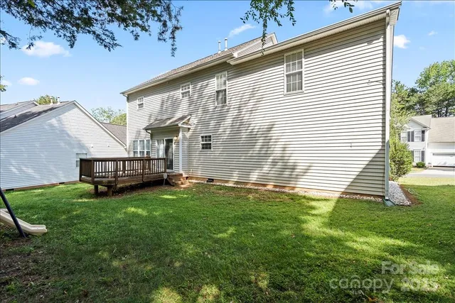 a view of backyard of house with green space