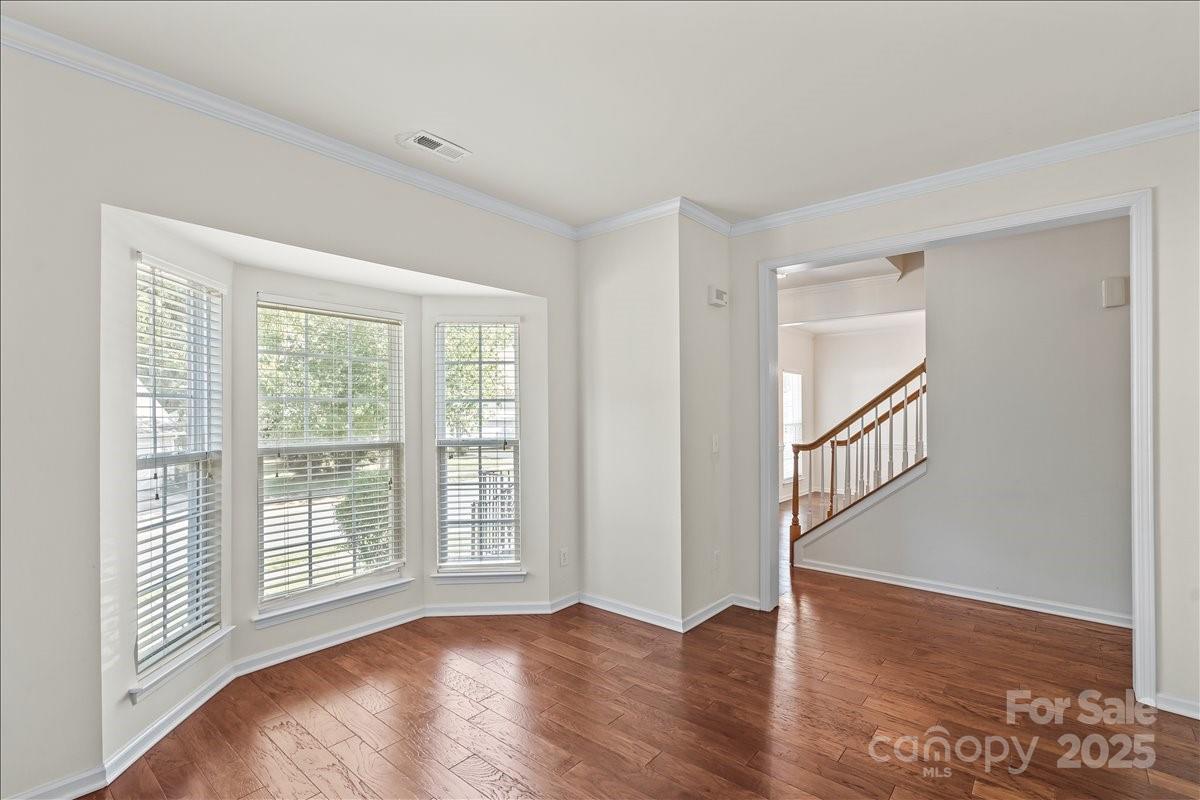 11938 Harmon Lane Pineville, NC 28134 - Photo 8 of 36 a view of an empty room with wooden floor and a window