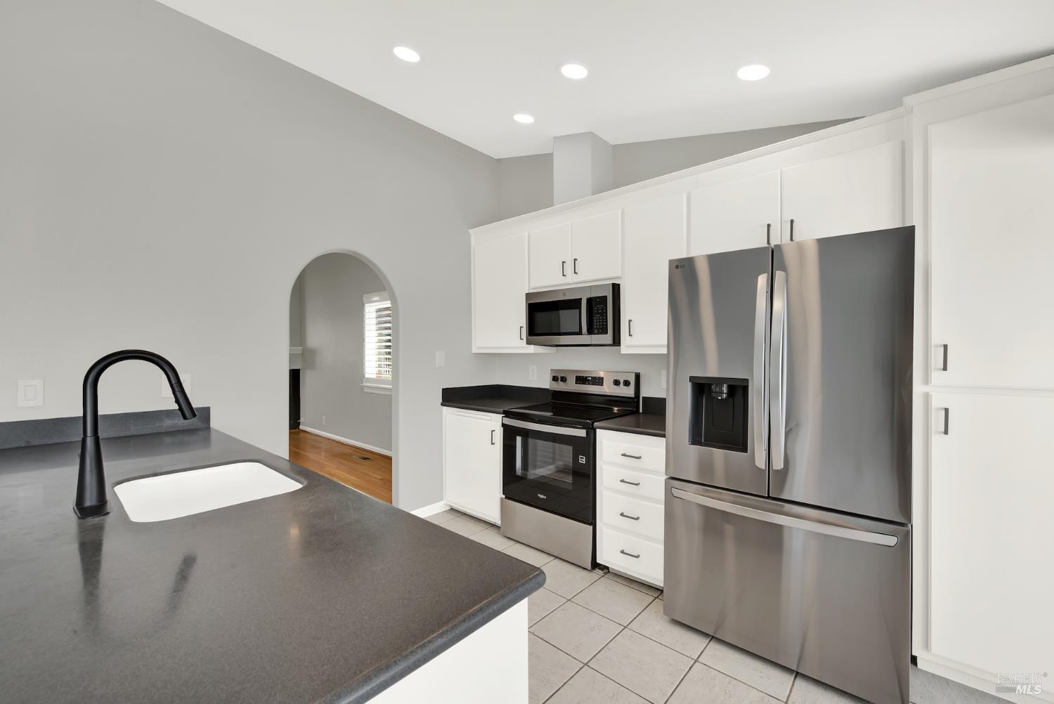 1270 Willow Lake Road Discovery Bay, CA 94505 - Photo 10 of 29 a kitchen with stainless steel appliances granite countertop a refrigerator a stove a sink and a microwave