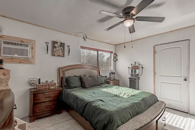a bedroom with a bed and a ceiling fan