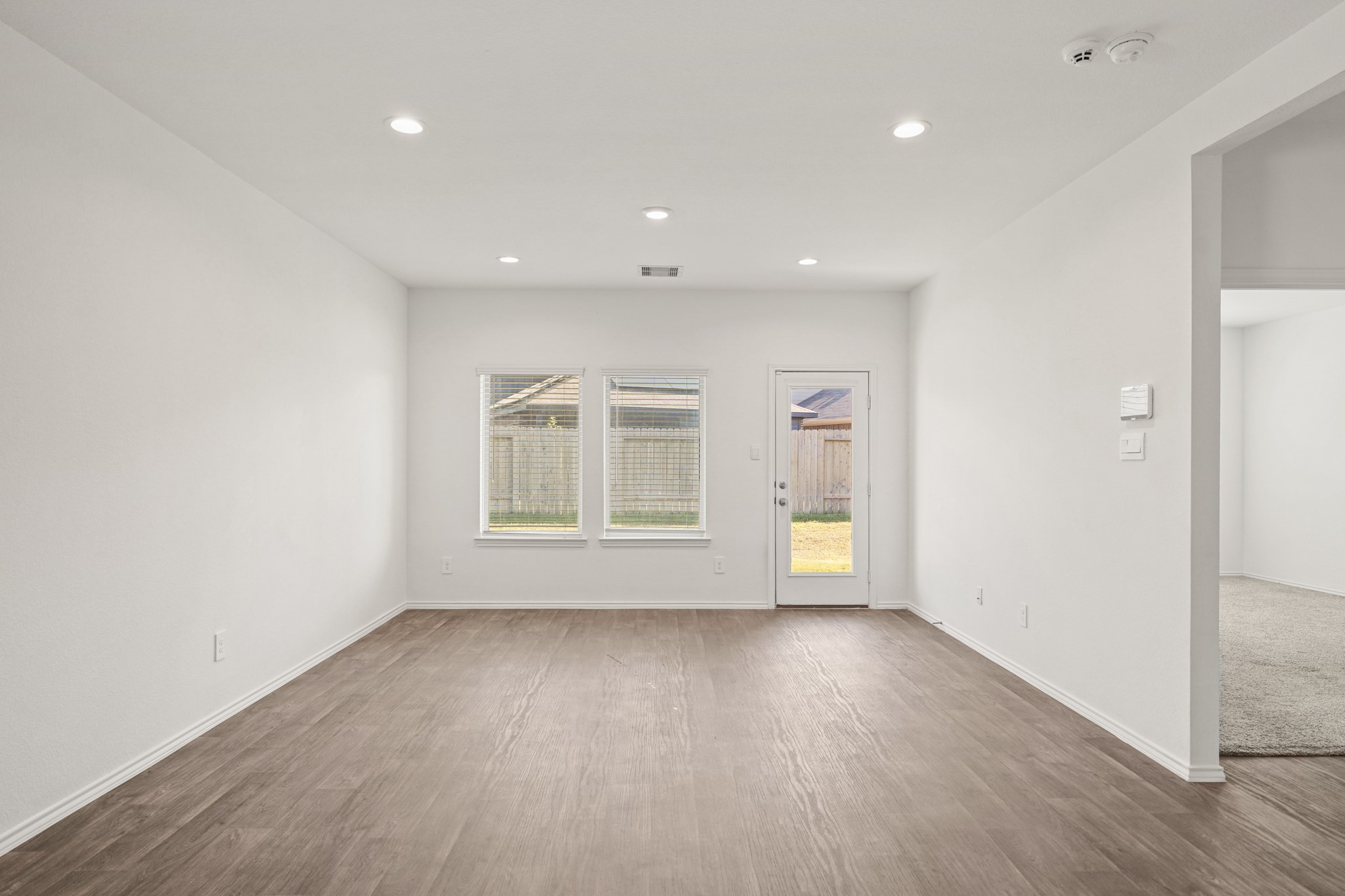 2406 Silver Prairie Ln Spring Spring, TX 77373 - Photo 11 of 30 an empty room with wooden floor and windows