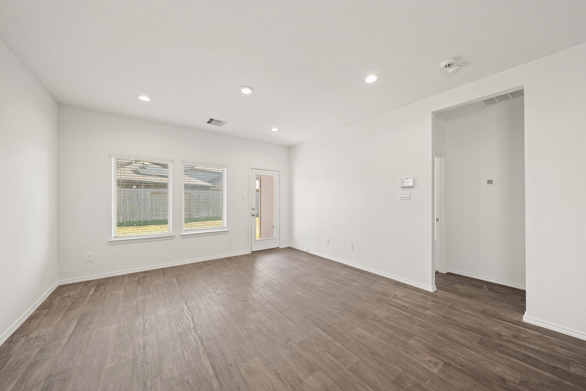 2406 Silver Prairie Ln Spring Spring, TX 77373 - Photo 12 of 30 a view of an empty room with wooden floor and a window