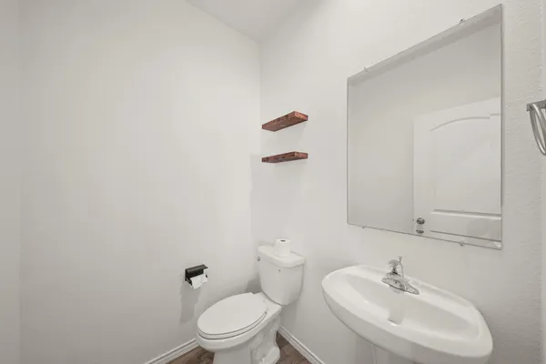 a bathroom with a sink a toilet and a mirror